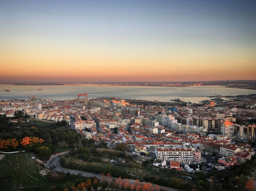 A cityscape overlooks water during a beautiful sunset.