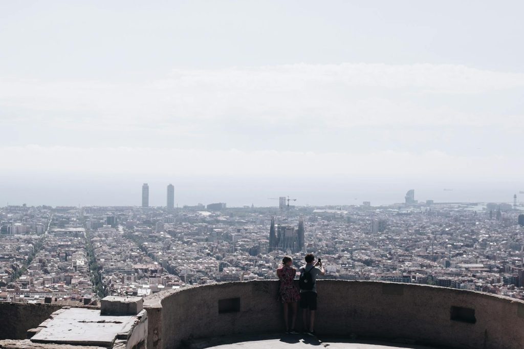 Breathtaking aerial view of Barcelona's skyline with iconic landmarks and clear sky, ideal for travel enthusiasts.